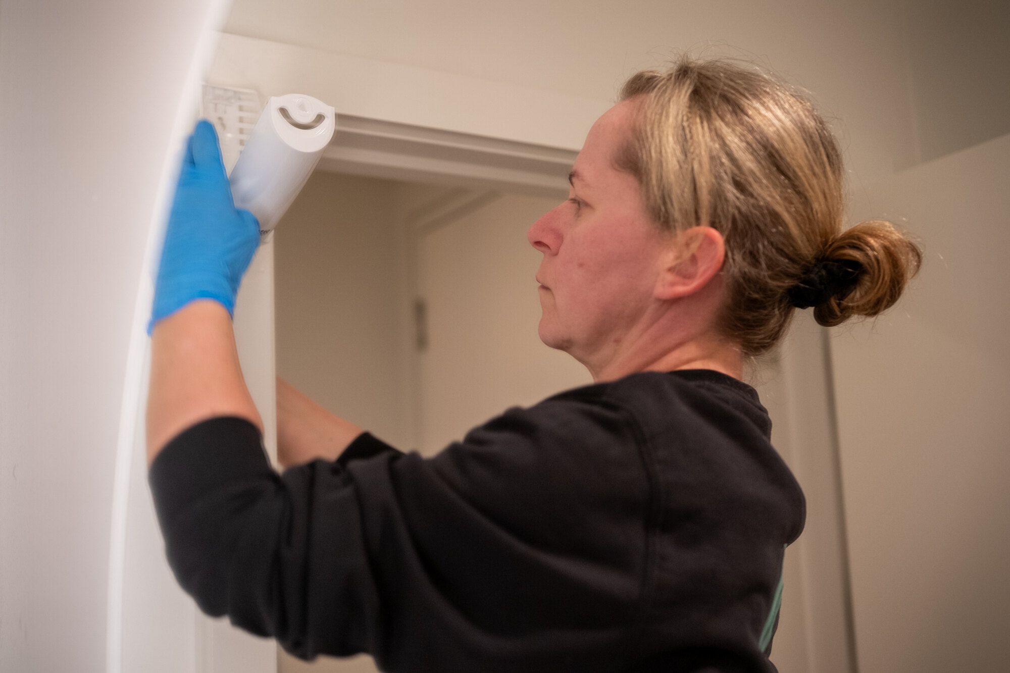A member of the Source washroom team servicing a dispenser